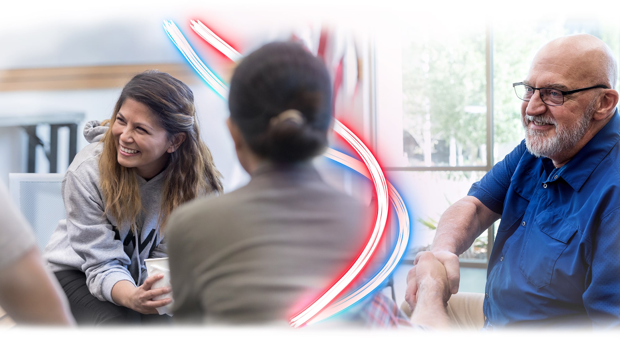 Three veterans are pictured. First, on the left side of the image is a woman holding a thermal disposable coffee cup. She is smiling to her right at something offscreen and wearing a grey hooded sweatshirt with black pants. In the middle is a woman with dark hair and her back to the viewer. The red and blue neon stripes that meander down the page wrap around her as they continue through the piece. On the far right is a bald man with glasses and a slight beard. He is looking at the woman who has her back to the camera and smiling.